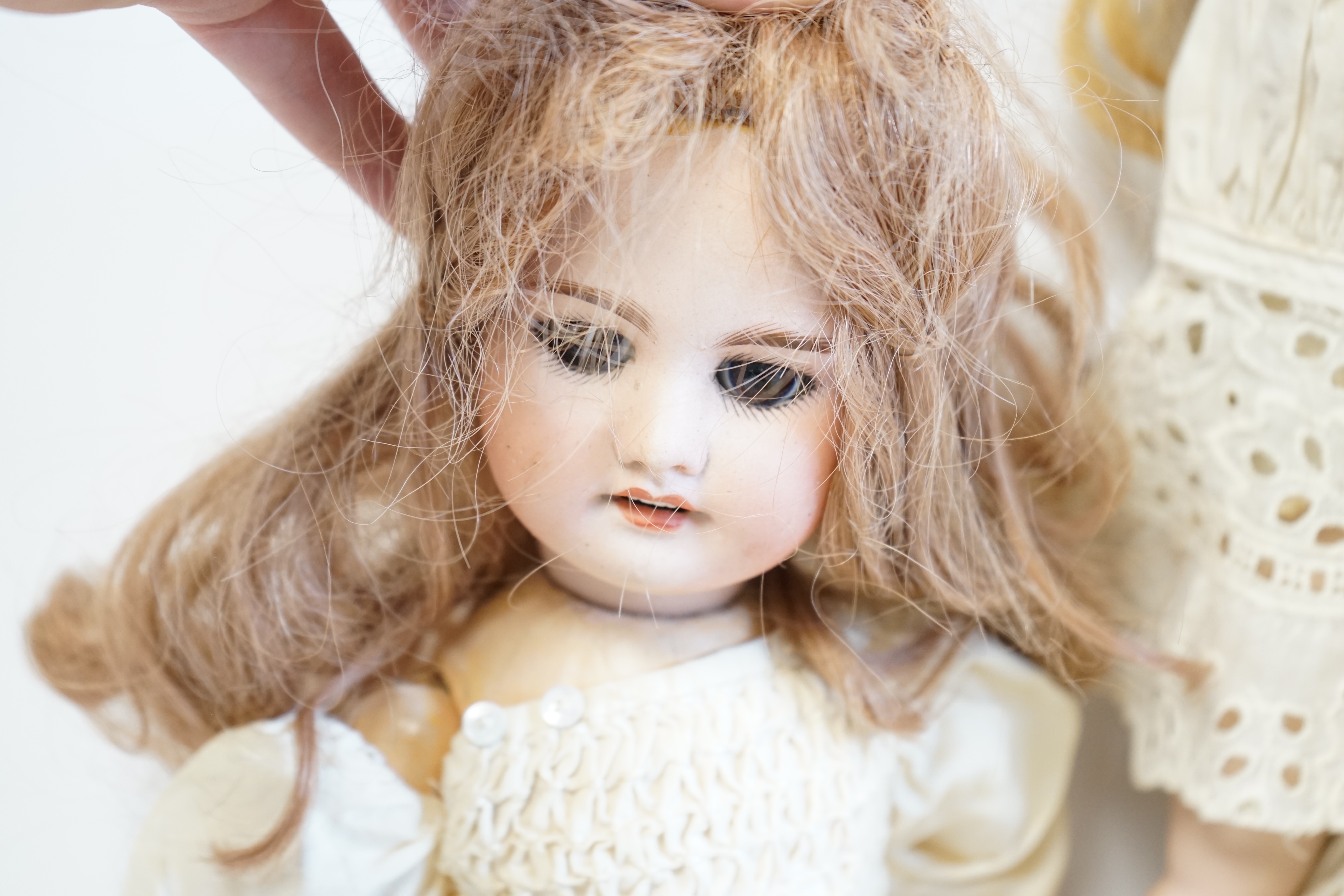 A German bisque shoulder plate doll marked bb on kid body, 60cm high, together with an SFBJ60, 42cm, and a Unis France, 36cm high (3). Condition - good